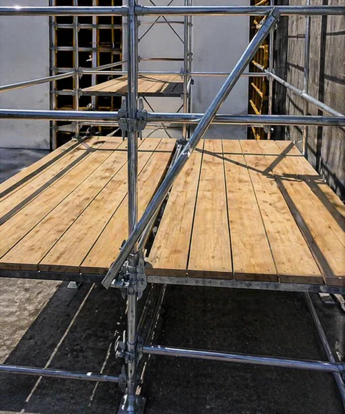 Installed wooden scaffolding planks used as walkway on site